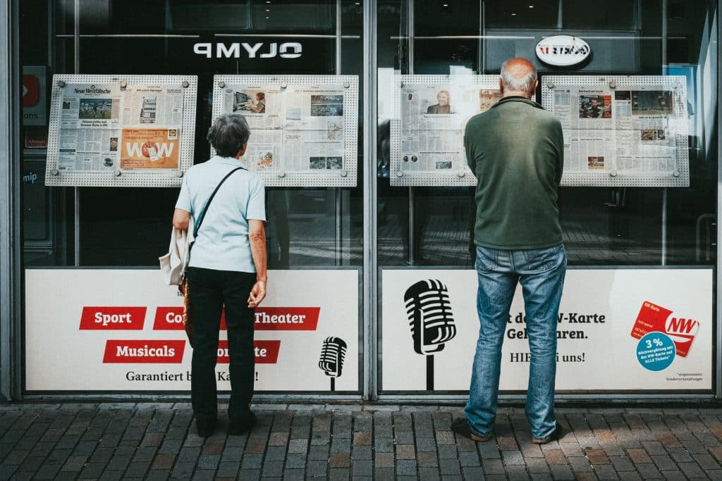 People reading headlines